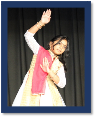 A young child dancing on stage
